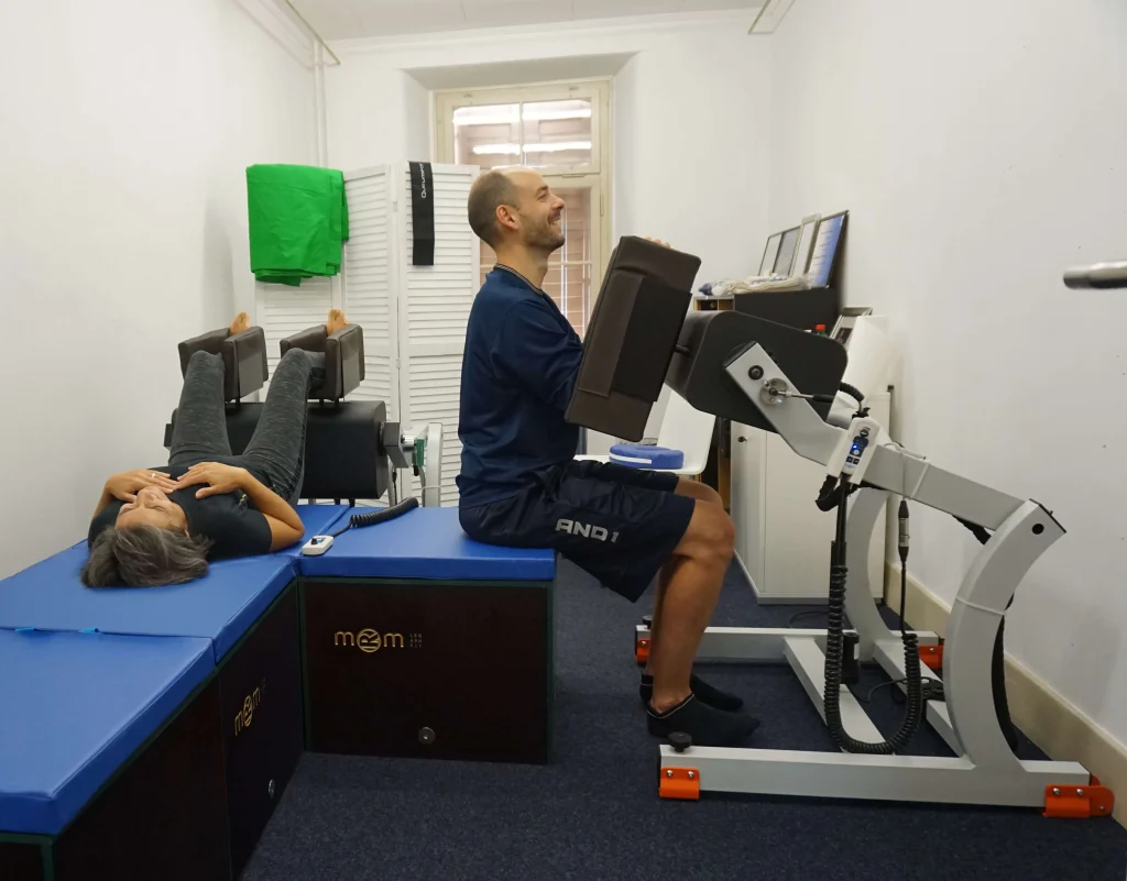Des personnes utilisent des équipements MRM dans un centre de physiothérapie, qui complètent le travail des thérapeutes dans la préparation et la récupération des athlètes et des patients, sans remplacer le contact humain professionnel.